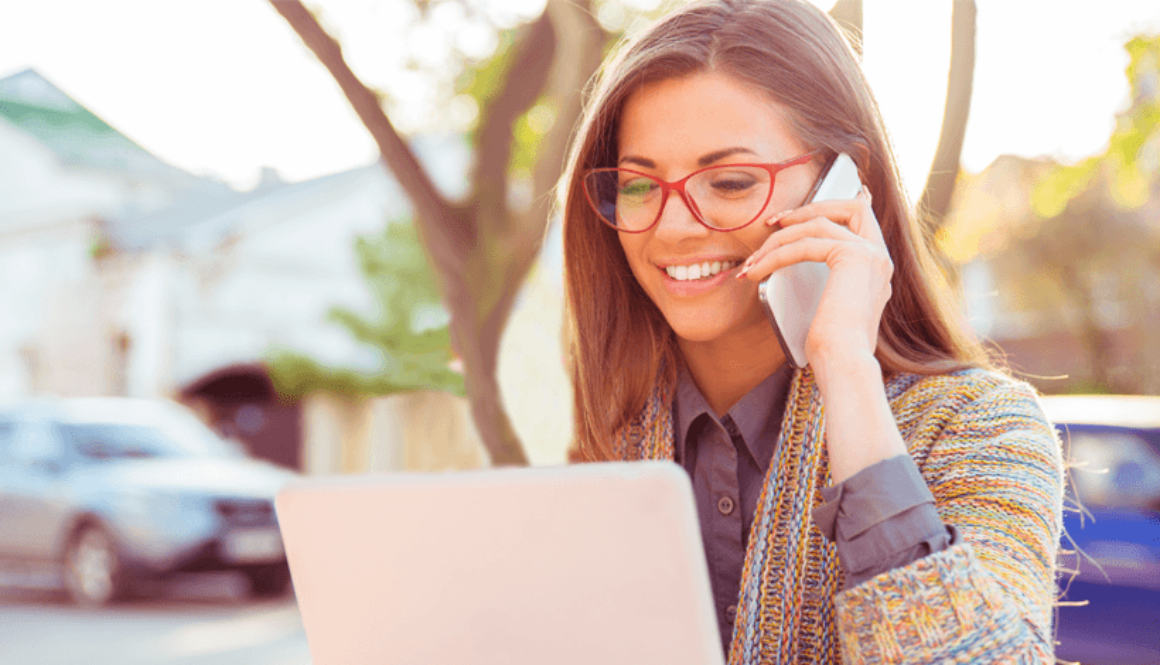 woman on cell phone with laptop