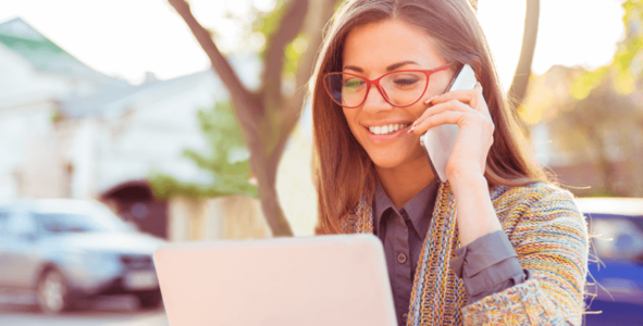 woman on cell phone with laptop